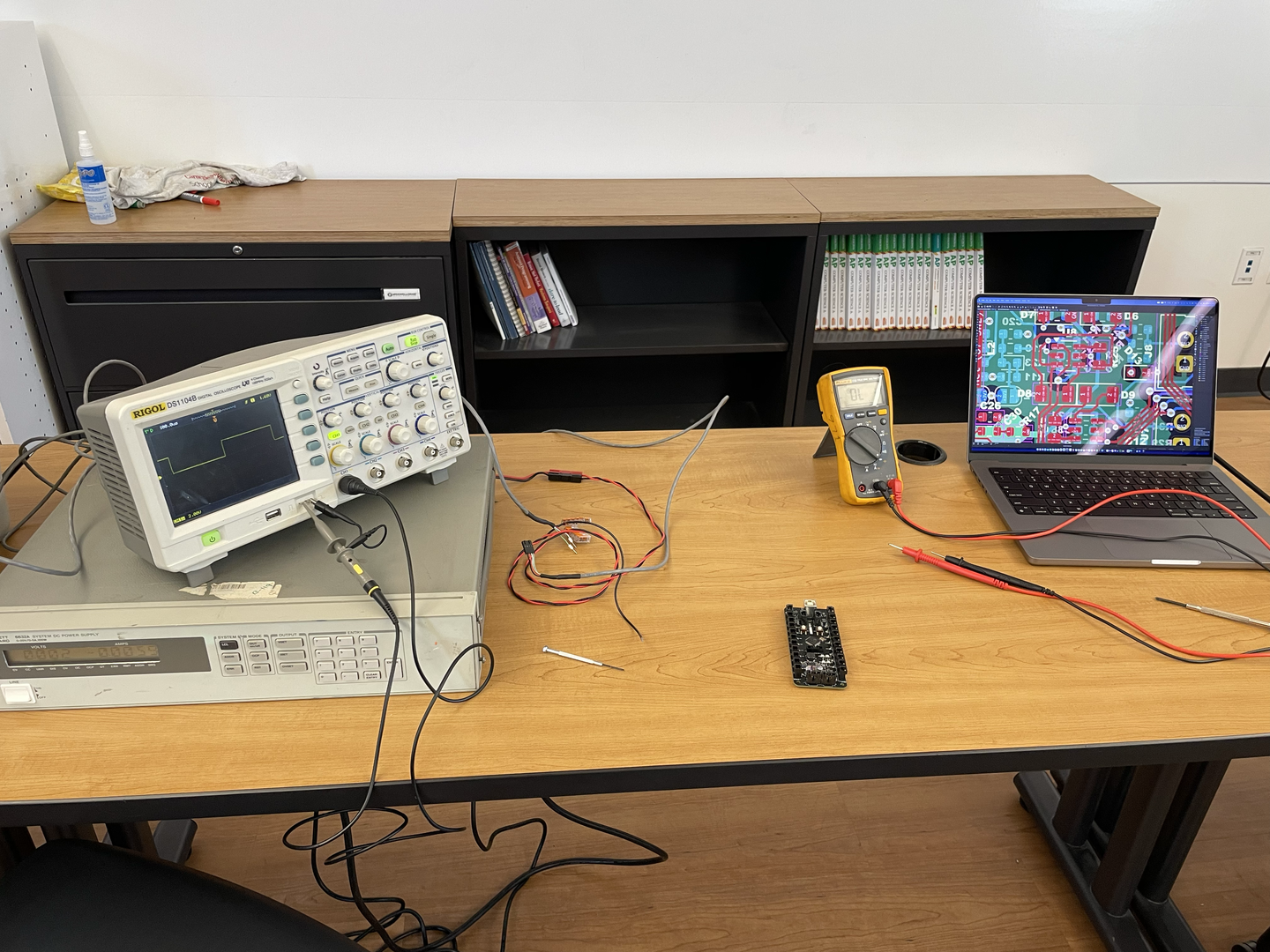 Hardware debugging session with logic analyzer and test equipment connected to verify signal integrity and timing.