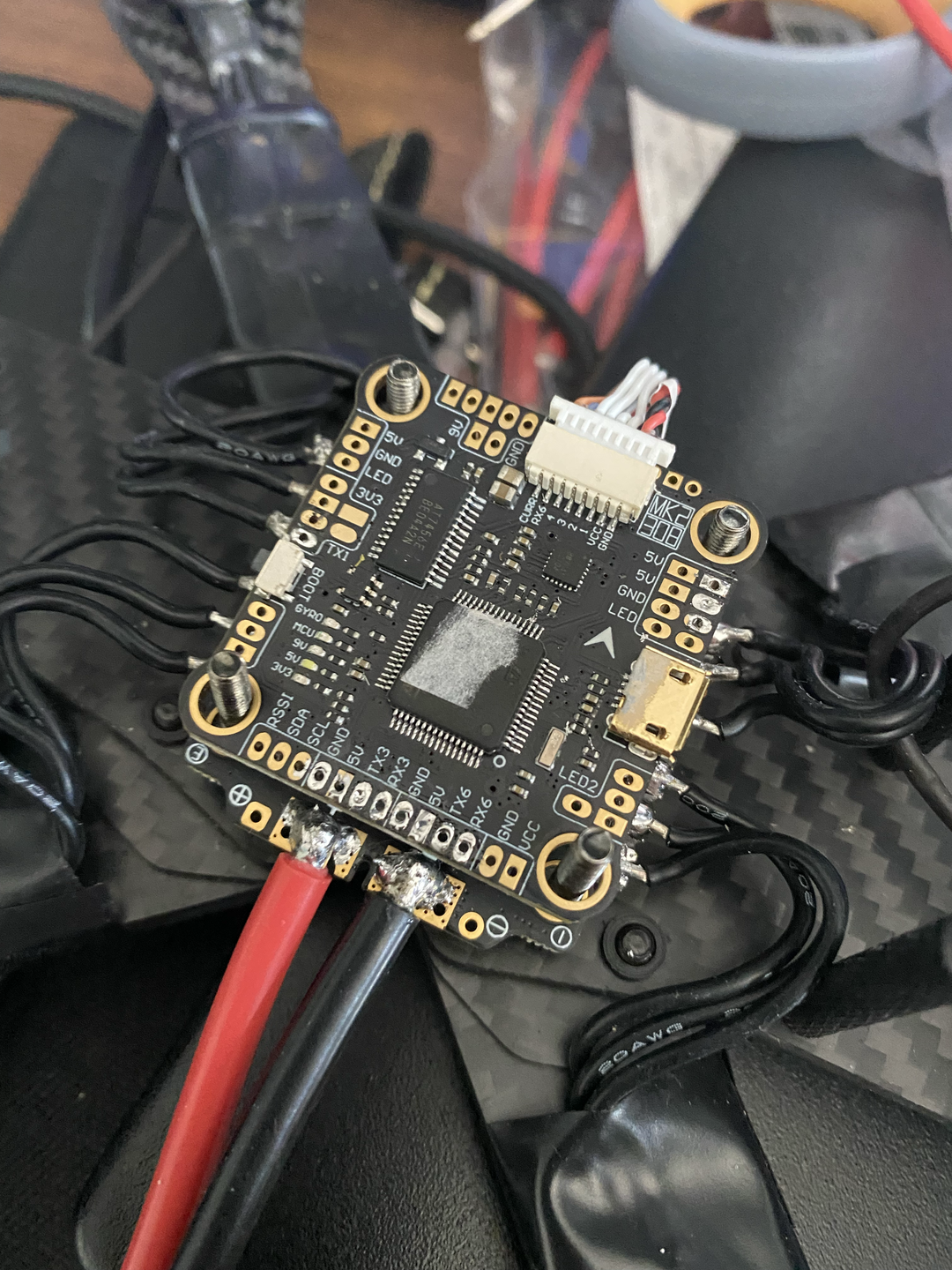 Soldering the flight controller connections for the drone.