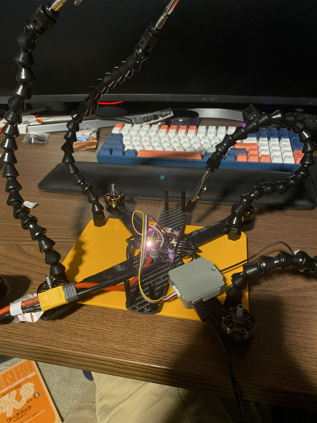 Securing and soldering motor wires directly to the drone frame.