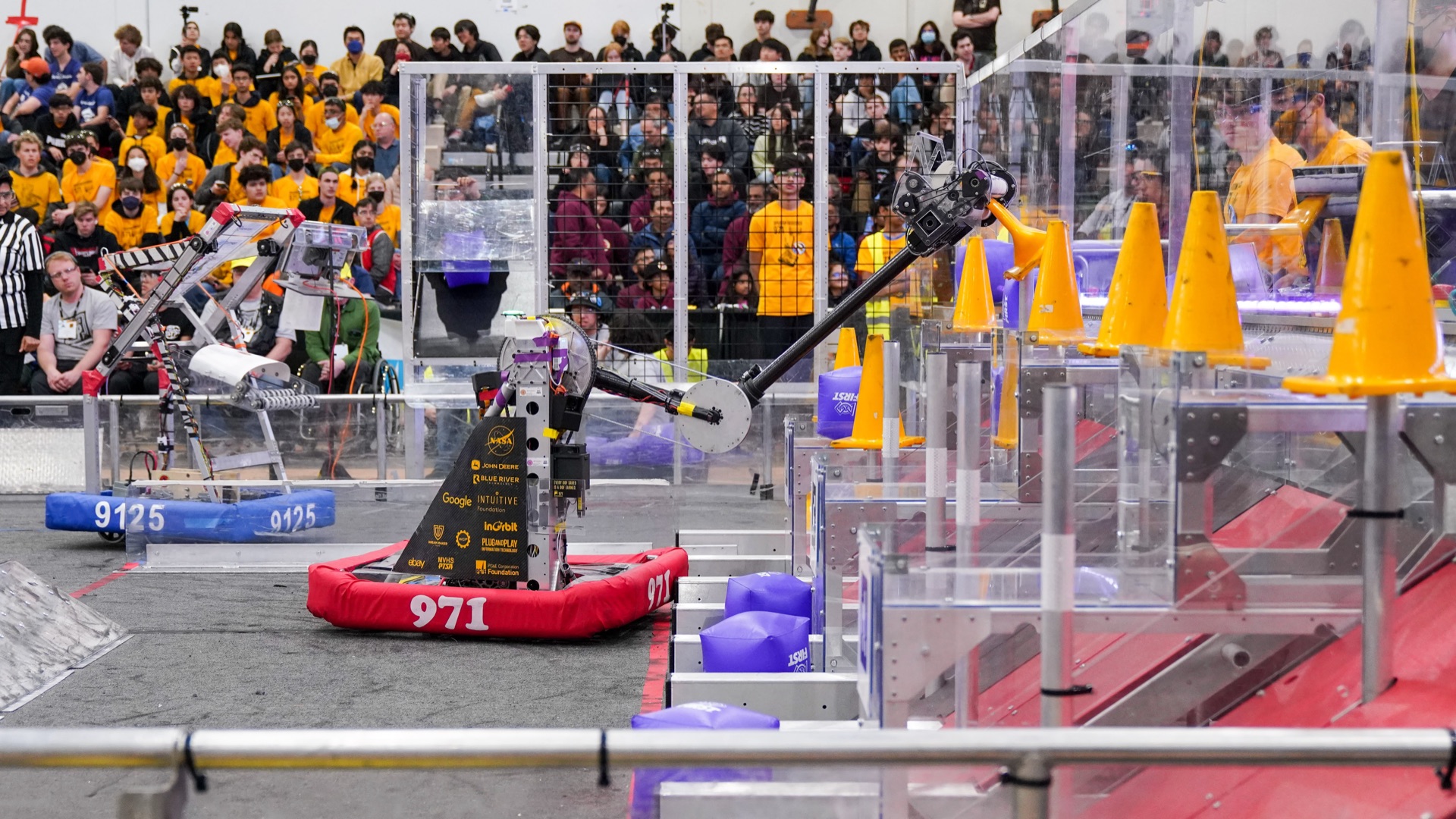 The 2023 arm at full stretch dropping a cone on the top level.