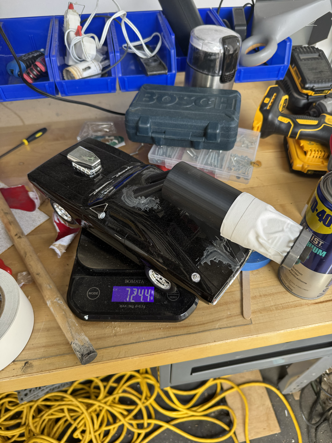 Weighing the rocket car on a scale to measure its total mass before launch.