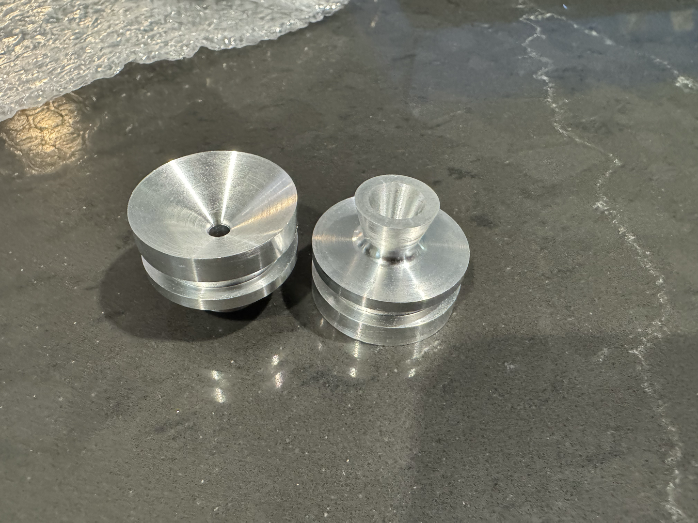 Custom-fabricated converging-diverging nozzle for supersonic exhaust flow.